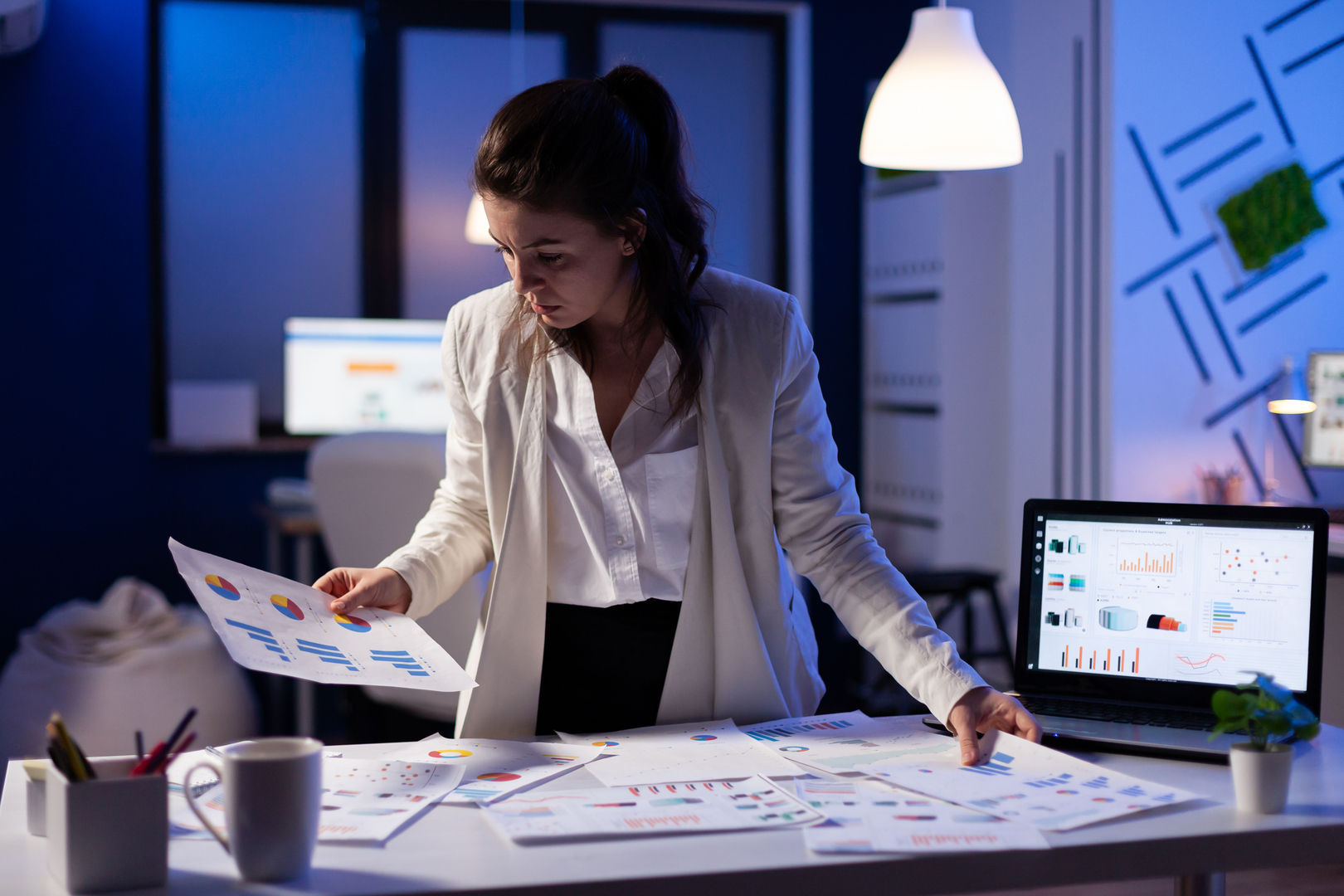 Busy business woman working on financial reports checking numbers
